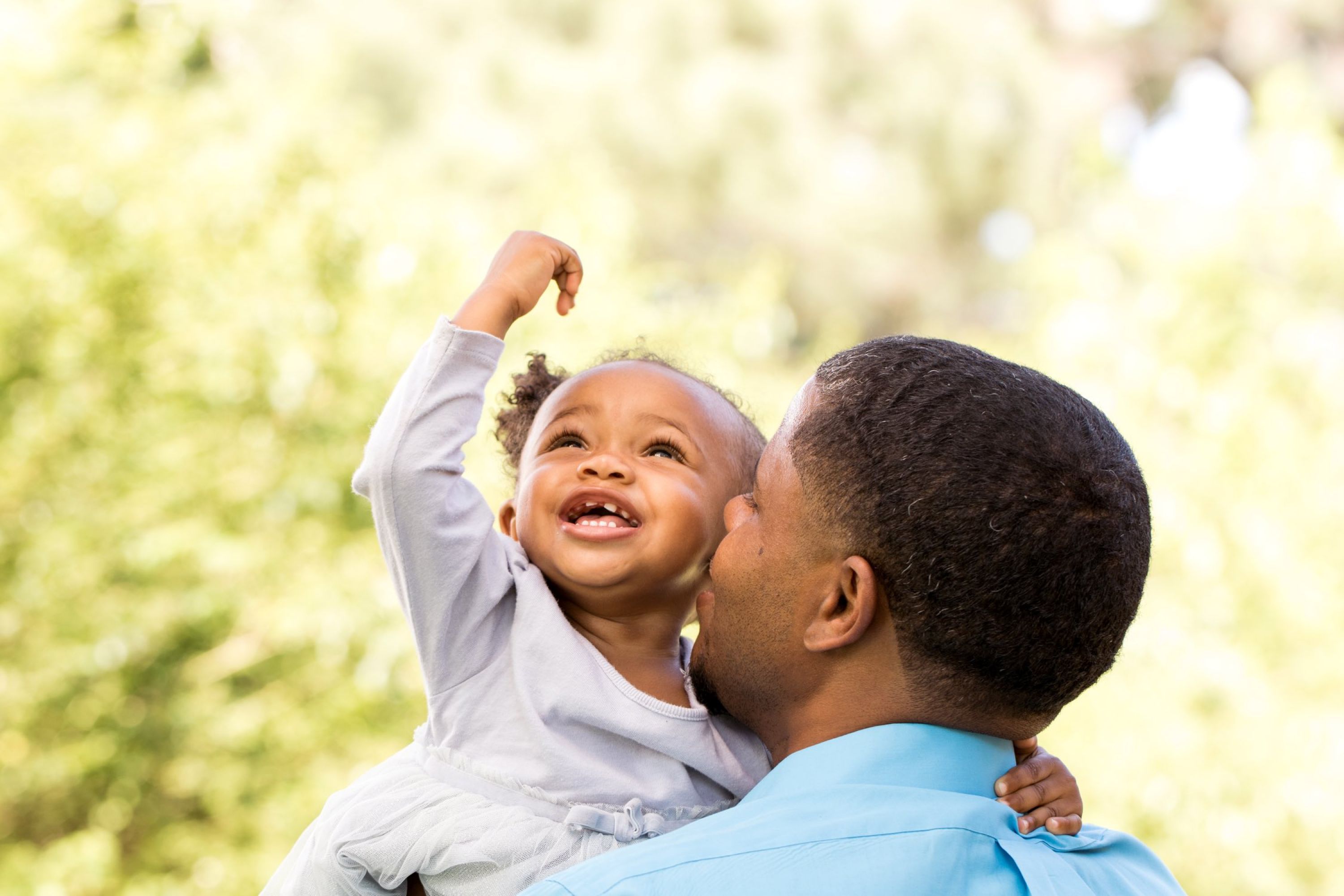 Image of man holding a smiling little girl.