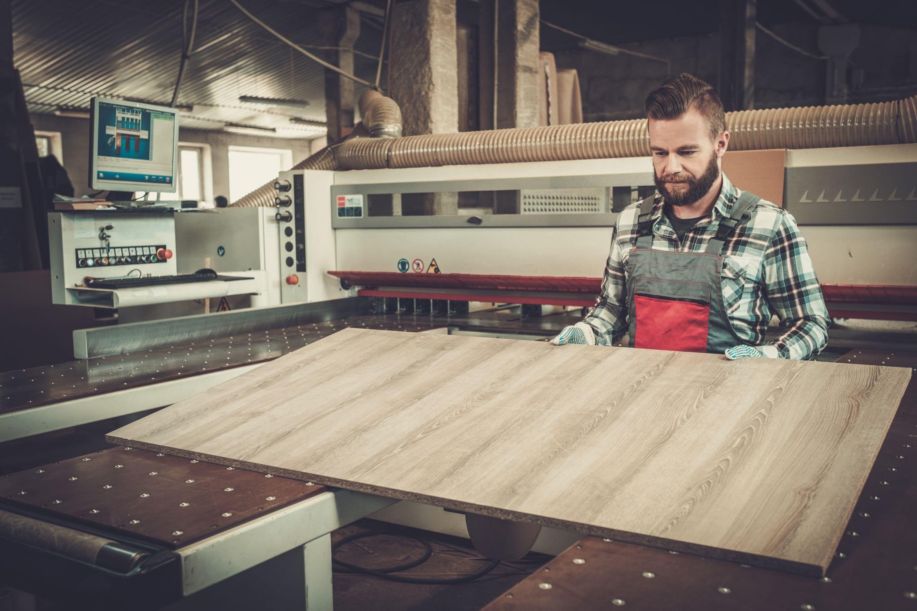 Image of a wood worker in a work shop.