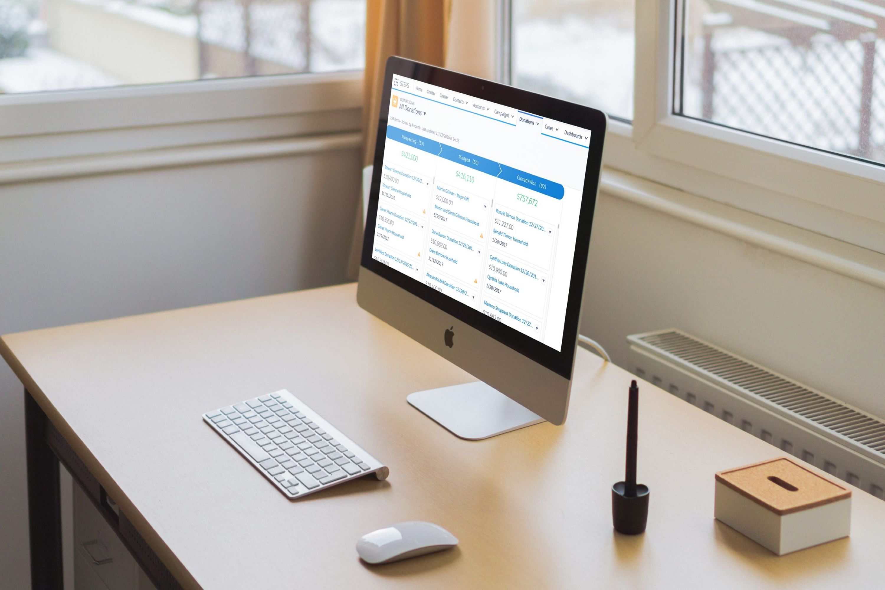 Image of a computer screen on a desk in a bright sunny room.