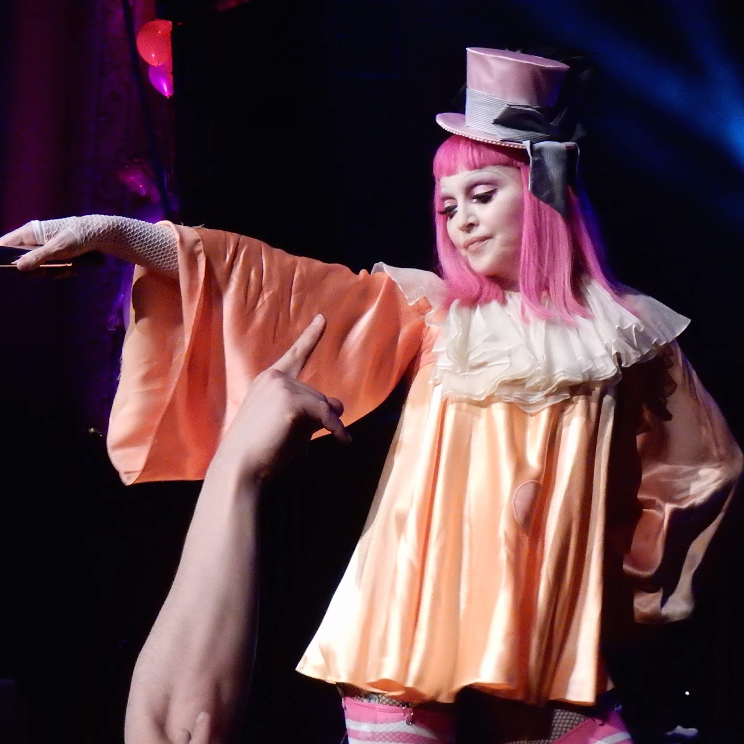 Image of Madonna with pink hair and a top hat.