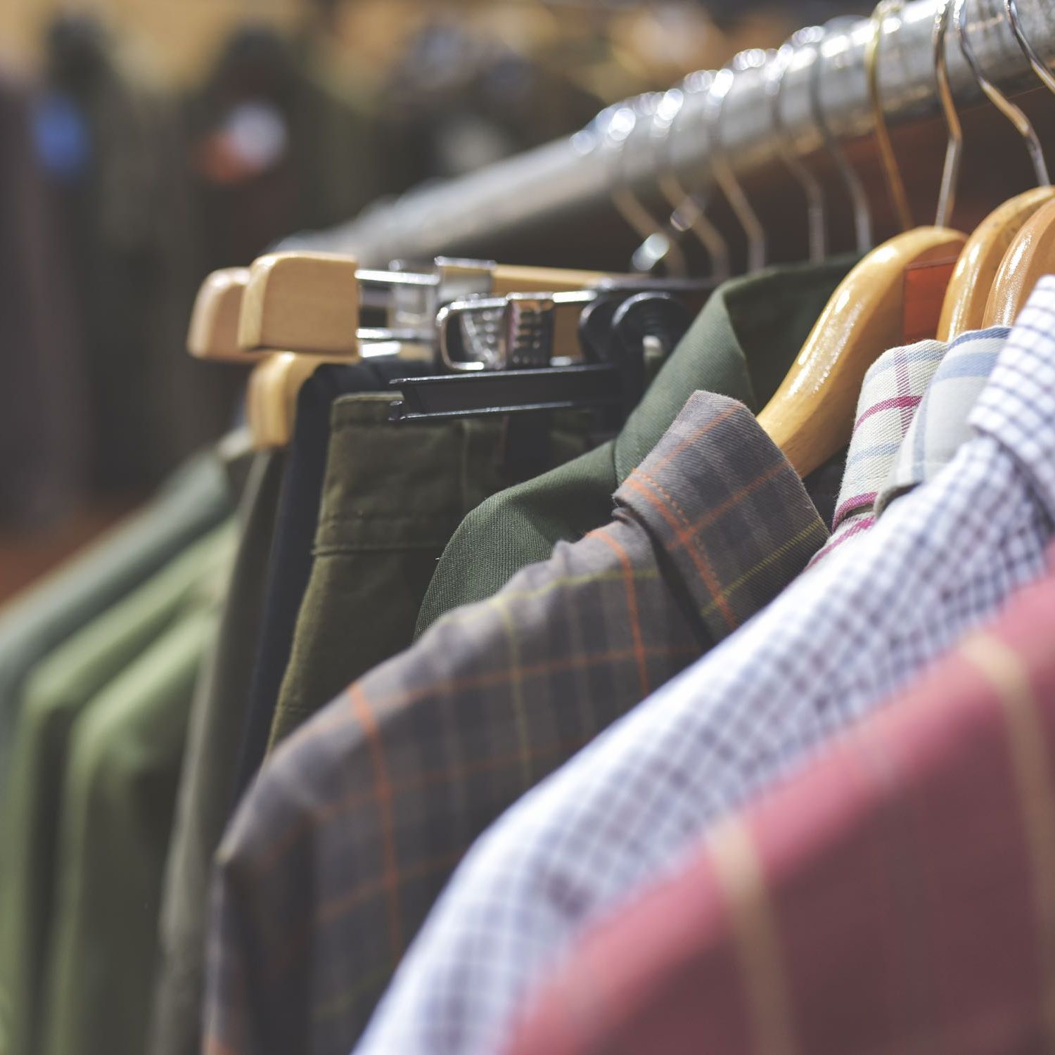 Closeup image of clothes on hangers in a closet.