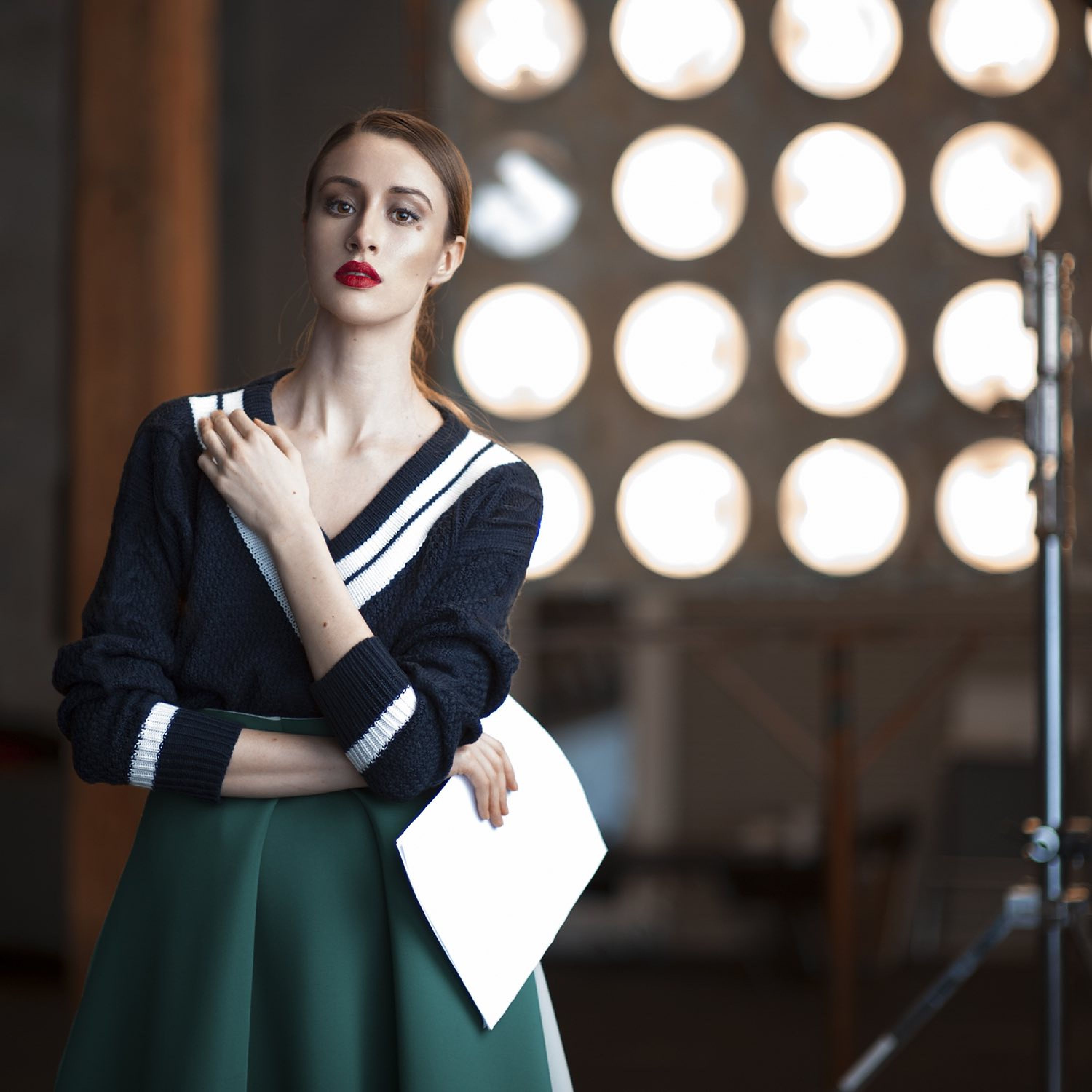 Image of woman with a script on stage.