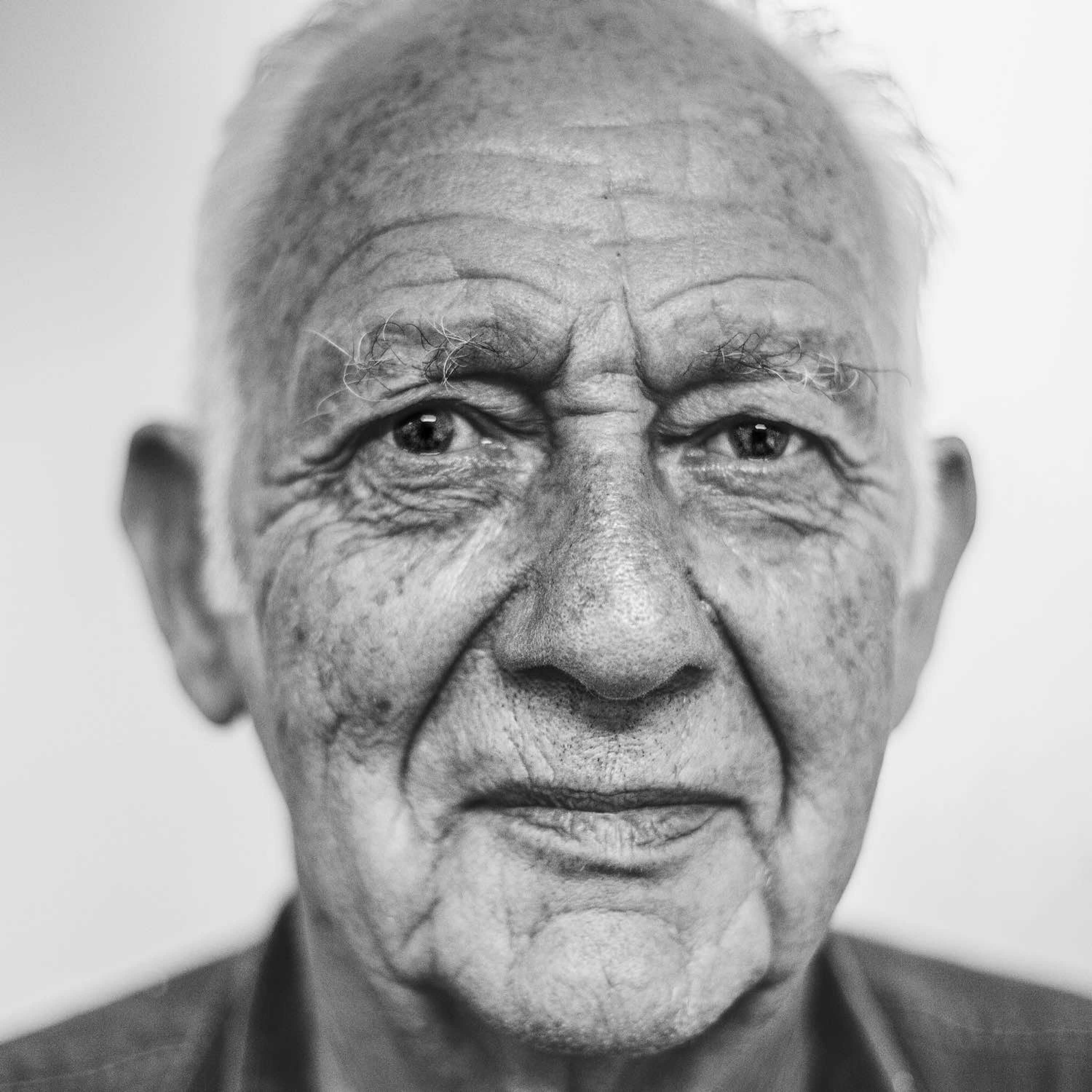 Black and white image of an elderly man.