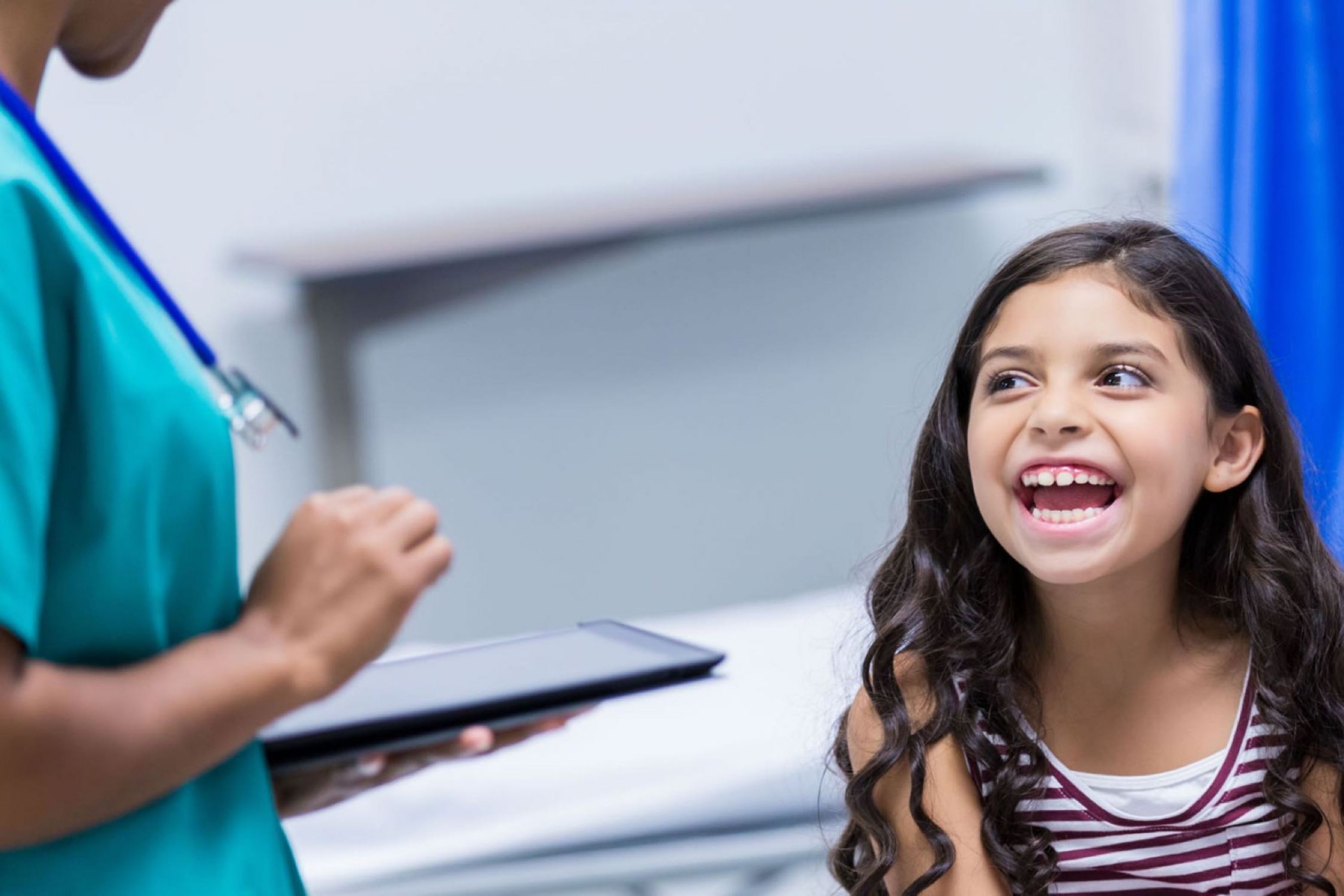 Image of young smiling girl in a doctors office.