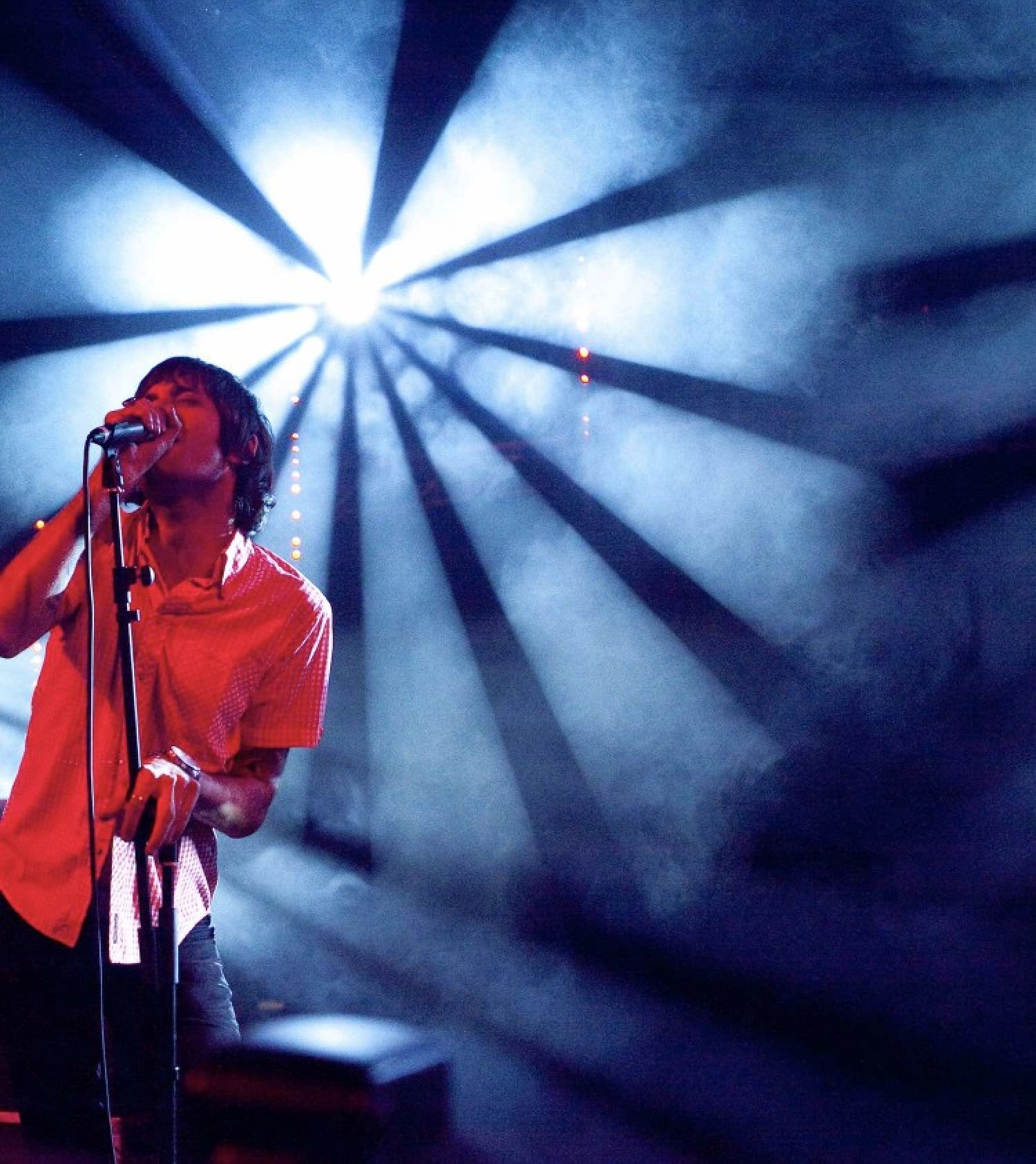 Man singing at microphone.