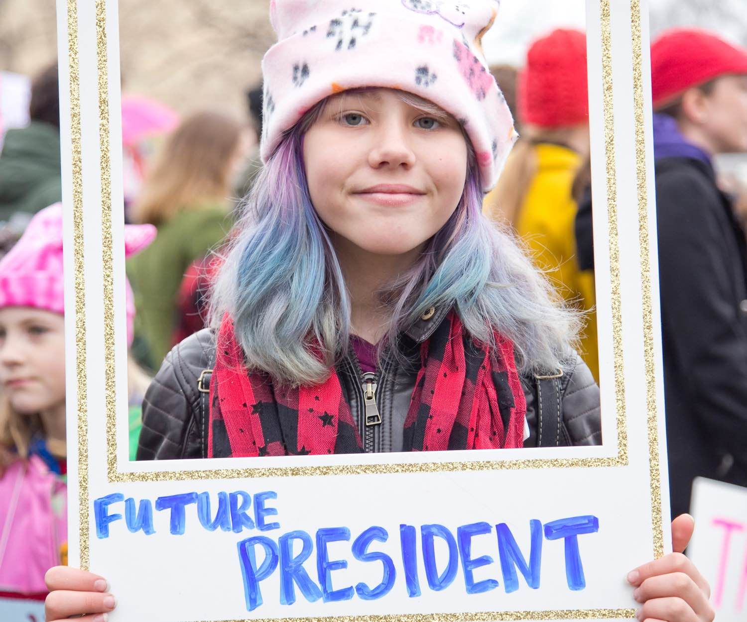 Image of young girl holding a sign that says "Future President".