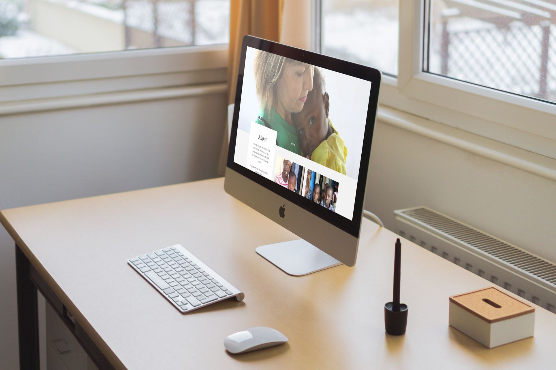 Computer on a desk with image of woman and child.