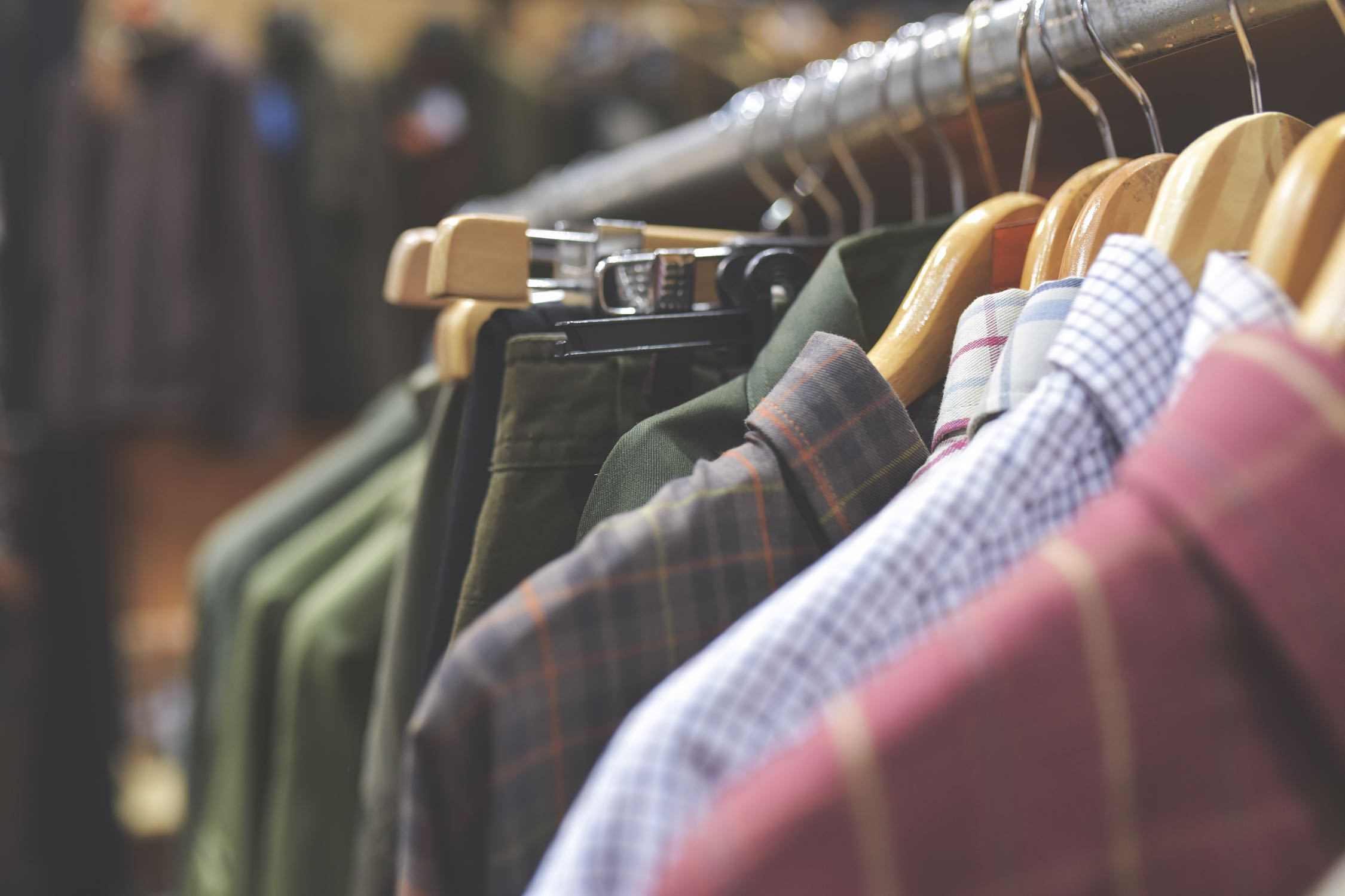 Closeup image of clothes on hangers in a closet.