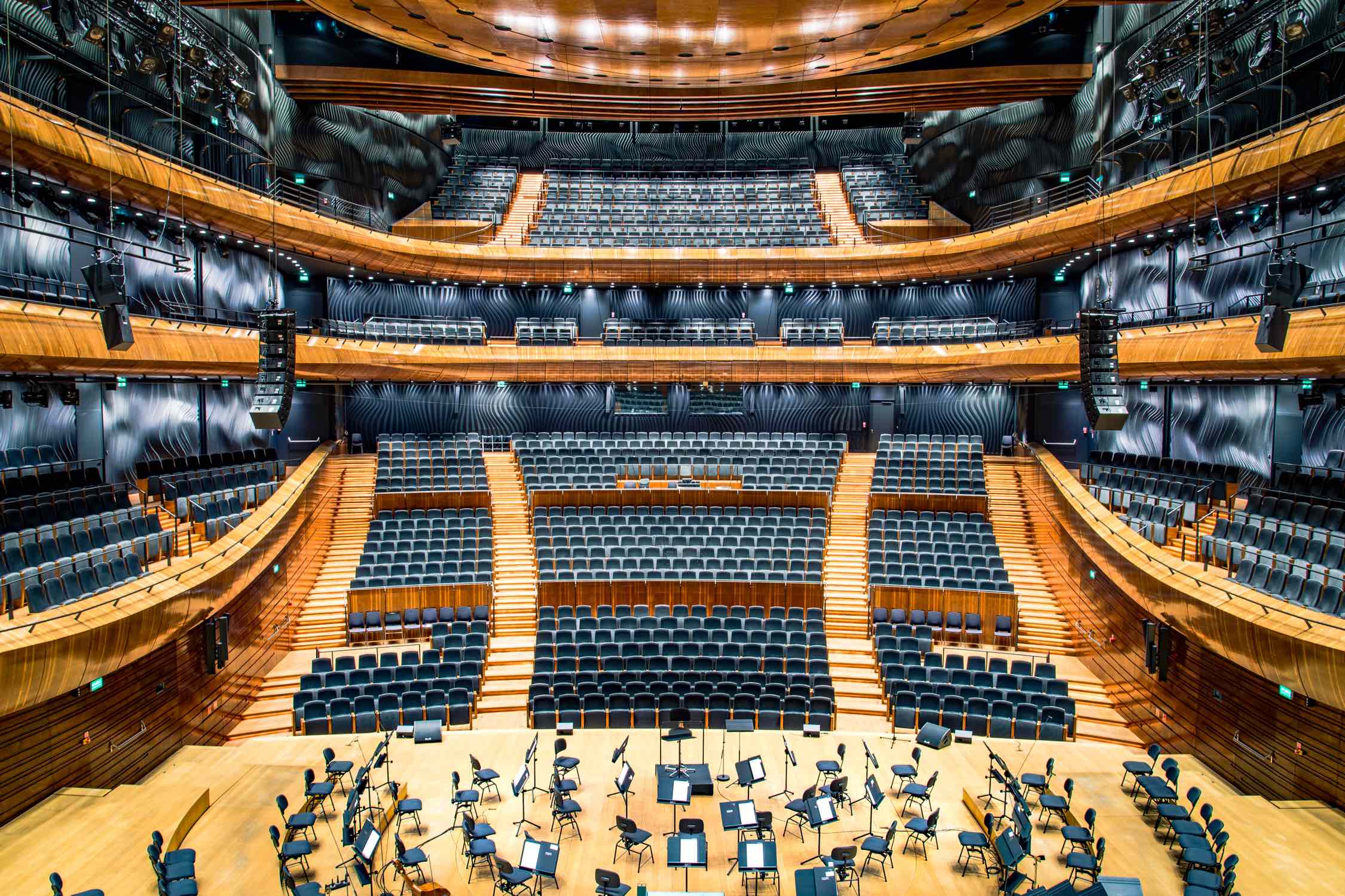 An orchestra hall with empty chairs.