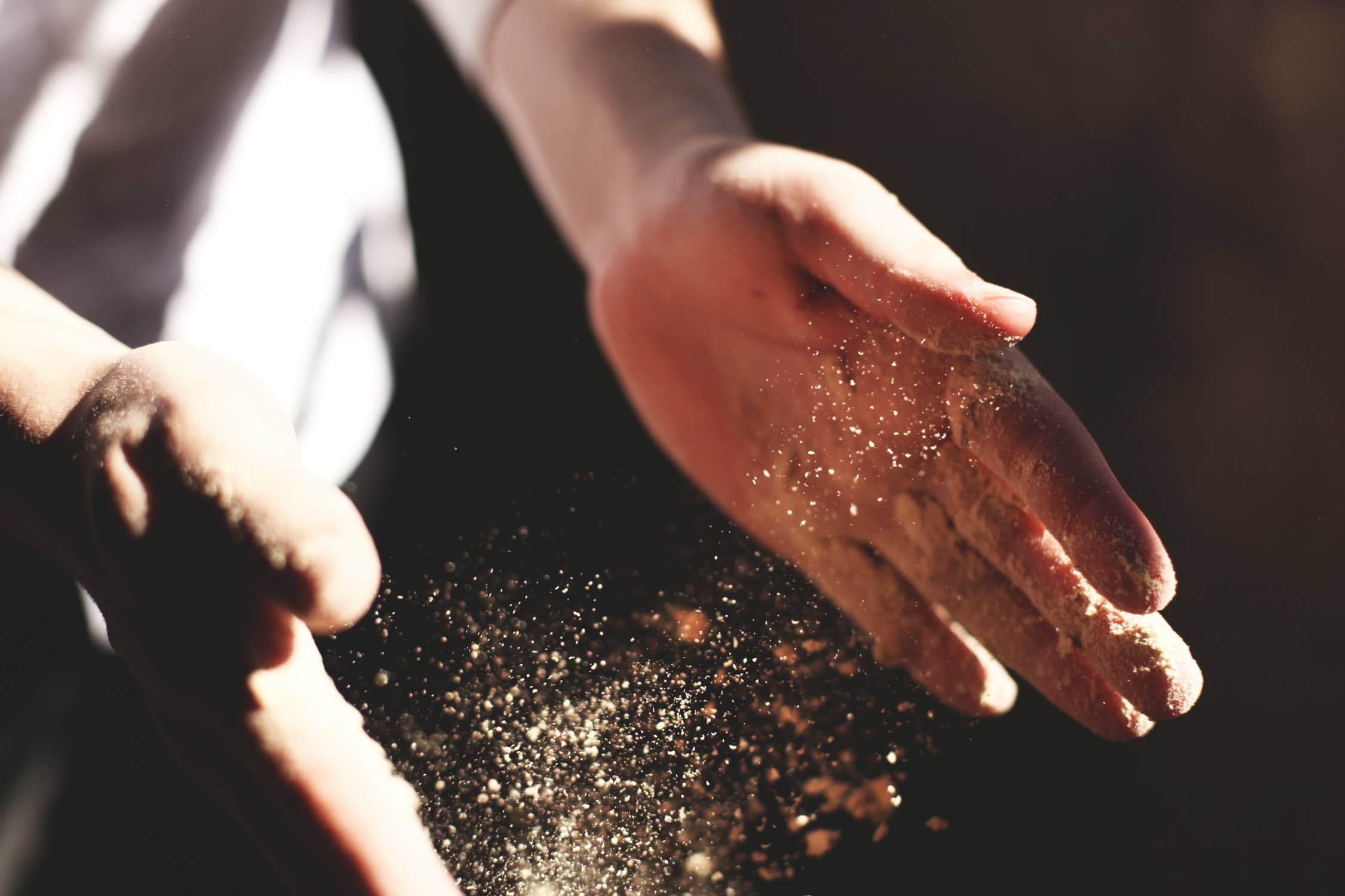 Image of hands dusting off flour.