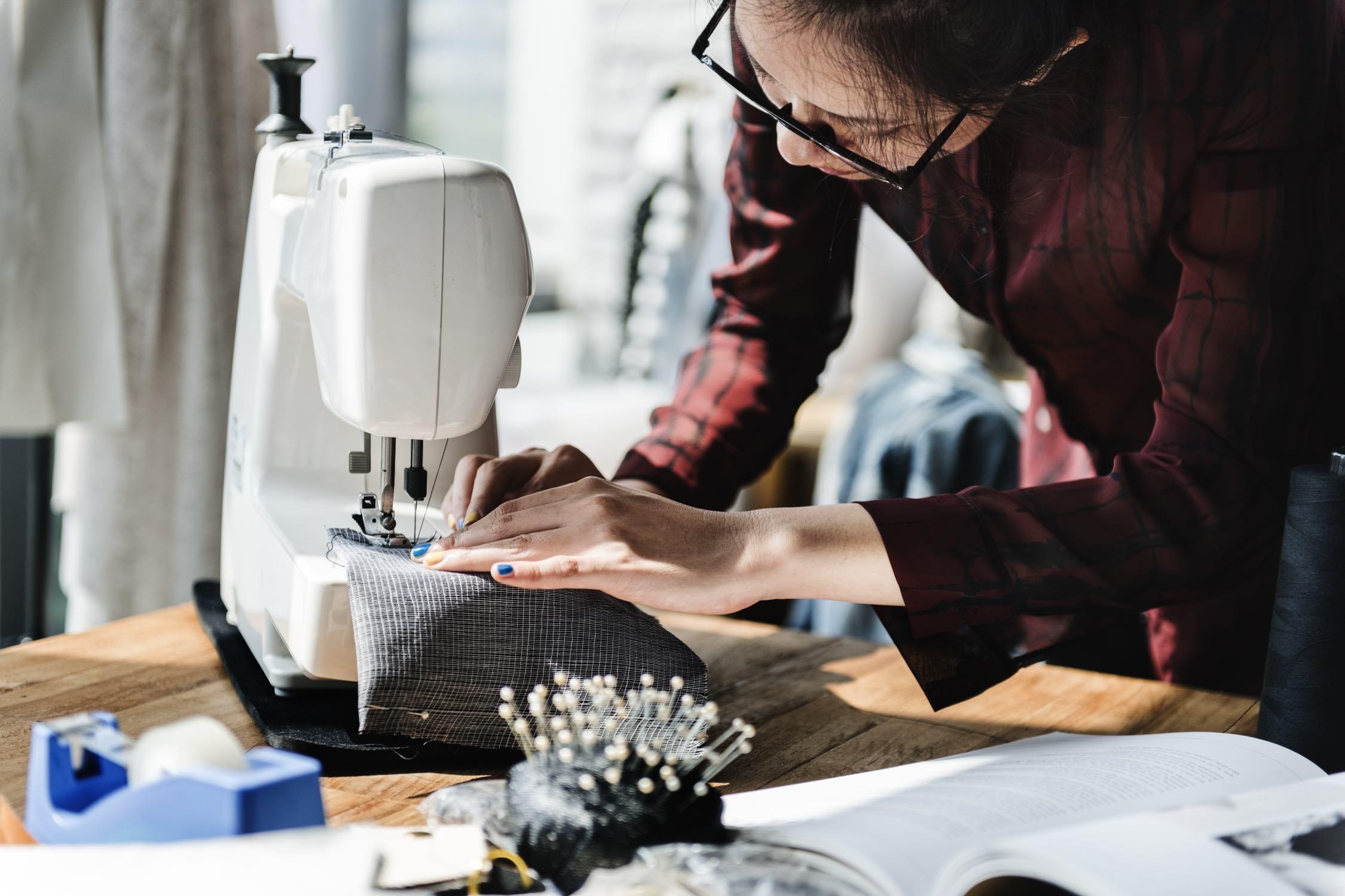 Woman at a sewing machine.