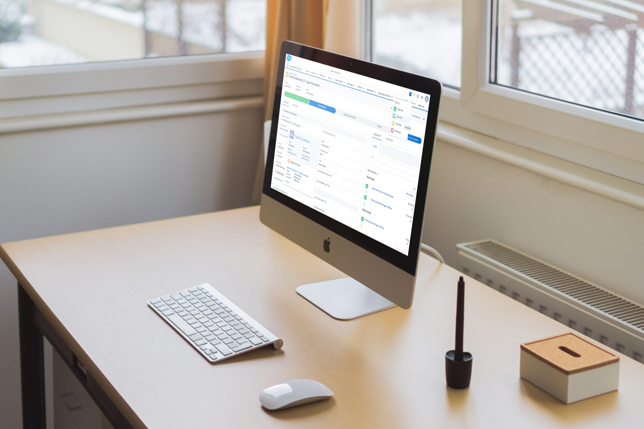 Image of a computer screen on a desk in a white bright and sunny room.