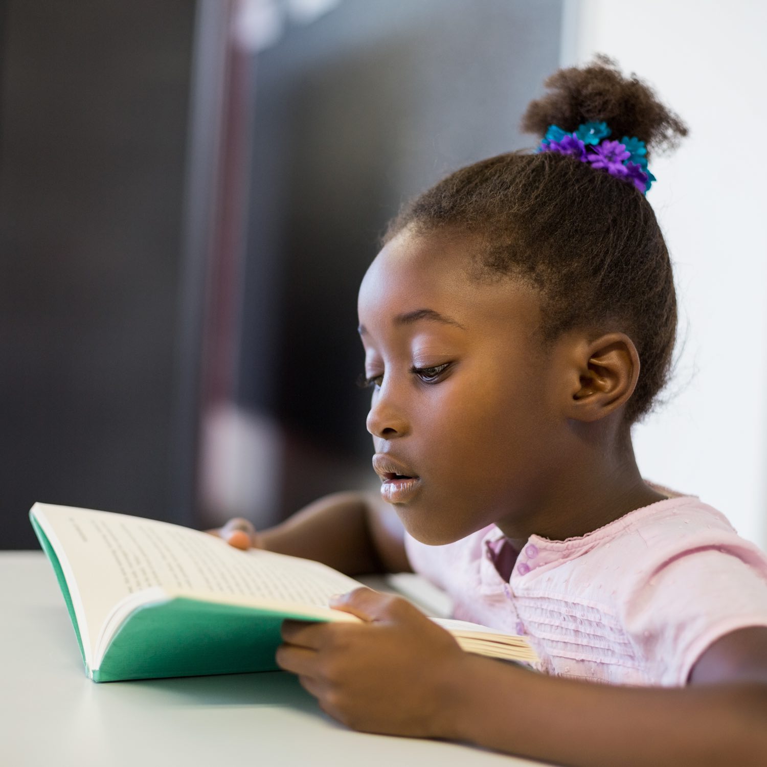 Image of young girl reading a book.